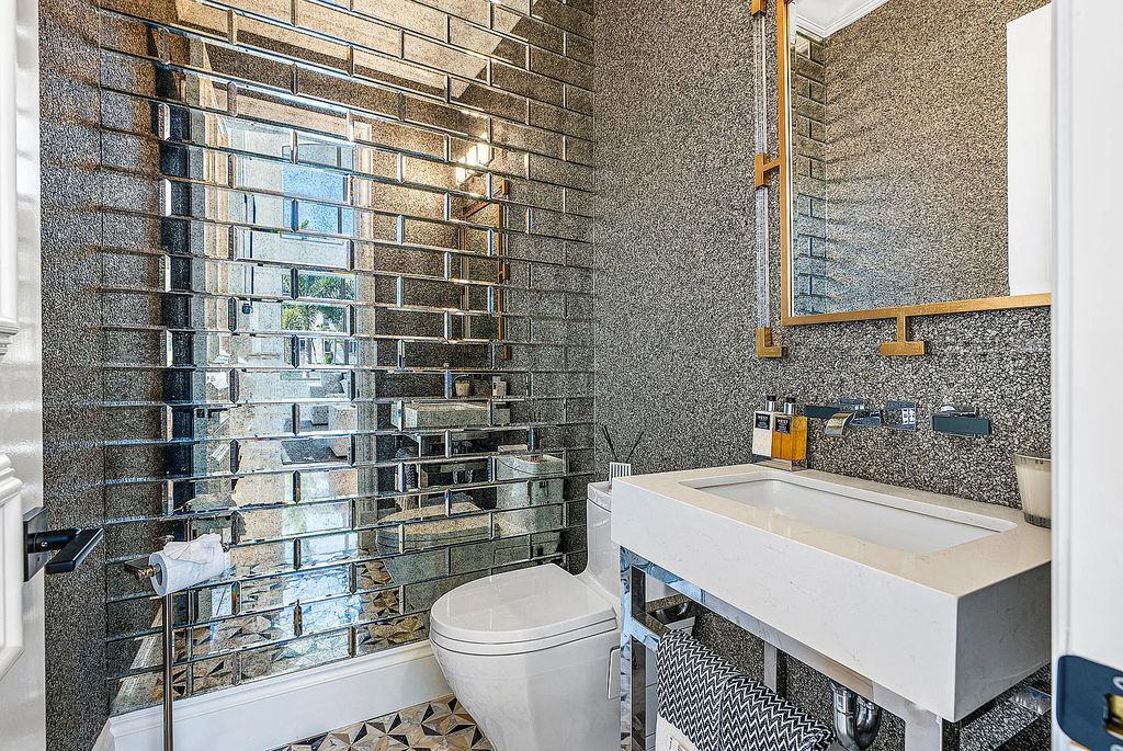 This exquisite 5 bedroom, 6 bathroom home is located on a prime waterfront lot in the highly sought-after area of Boca Raton, Florida. Built in 2003, 794 NE Harbour Drive boasts over 6,000 square feet of living space and sits on a spacious 0.22-acre lot. Upon entering the home, you'll be greeted by soaring ceilings and breathtaking water views that extend throughout the living areas, creating a bright and airy atmosphere.