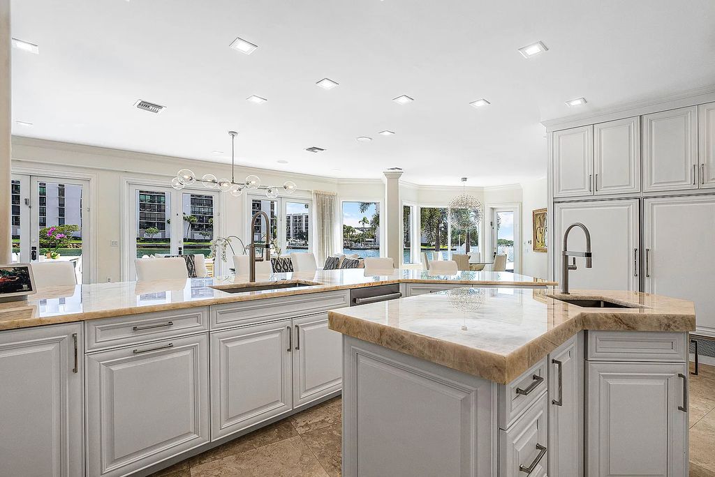 This exquisite 5 bedroom, 6 bathroom home is located on a prime waterfront lot in the highly sought-after area of Boca Raton, Florida. Built in 2003, 794 NE Harbour Drive boasts over 6,000 square feet of living space and sits on a spacious 0.22-acre lot. Upon entering the home, you'll be greeted by soaring ceilings and breathtaking water views that extend throughout the living areas, creating a bright and airy atmosphere.