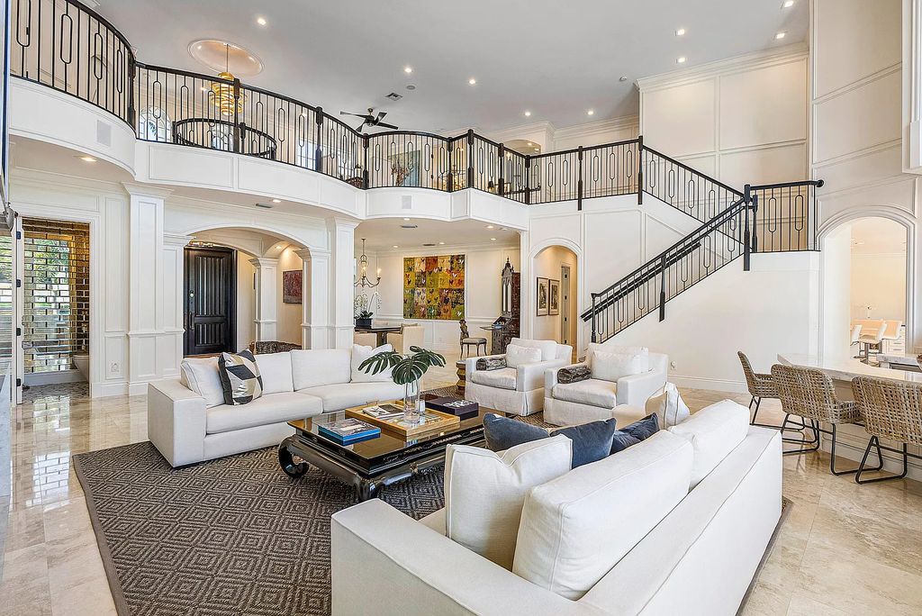 This exquisite 5 bedroom, 6 bathroom home is located on a prime waterfront lot in the highly sought-after area of Boca Raton, Florida. Built in 2003, 794 NE Harbour Drive boasts over 6,000 square feet of living space and sits on a spacious 0.22-acre lot. Upon entering the home, you'll be greeted by soaring ceilings and breathtaking water views that extend throughout the living areas, creating a bright and airy atmosphere.
