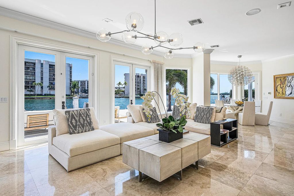 This exquisite 5 bedroom, 6 bathroom home is located on a prime waterfront lot in the highly sought-after area of Boca Raton, Florida. Built in 2003, 794 NE Harbour Drive boasts over 6,000 square feet of living space and sits on a spacious 0.22-acre lot. Upon entering the home, you'll be greeted by soaring ceilings and breathtaking water views that extend throughout the living areas, creating a bright and airy atmosphere.