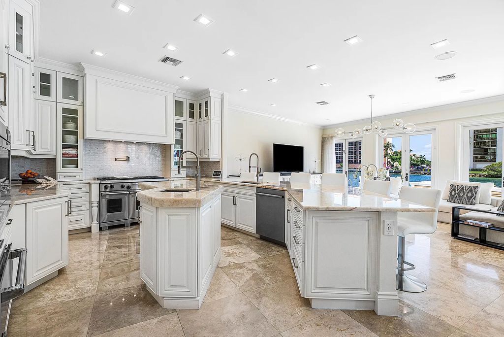 This exquisite 5 bedroom, 6 bathroom home is located on a prime waterfront lot in the highly sought-after area of Boca Raton, Florida. Built in 2003, 794 NE Harbour Drive boasts over 6,000 square feet of living space and sits on a spacious 0.22-acre lot. Upon entering the home, you'll be greeted by soaring ceilings and breathtaking water views that extend throughout the living areas, creating a bright and airy atmosphere.