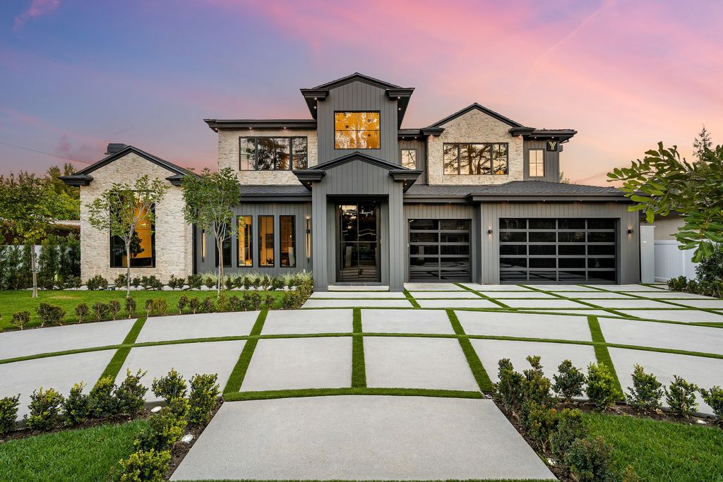 The recently built gated estate at 4508 Haskell Ave in Encino's prestigious Royal Oaks community is a true masterpiece of luxury and design. Upon entering the property, guests are welcomed by an impressive wide entry hallway with ultra-high ceilings and European oak floors. The hallway leads to the stunning living room with stone entertainment bars and a formal dining room with a fireplace and private patio.