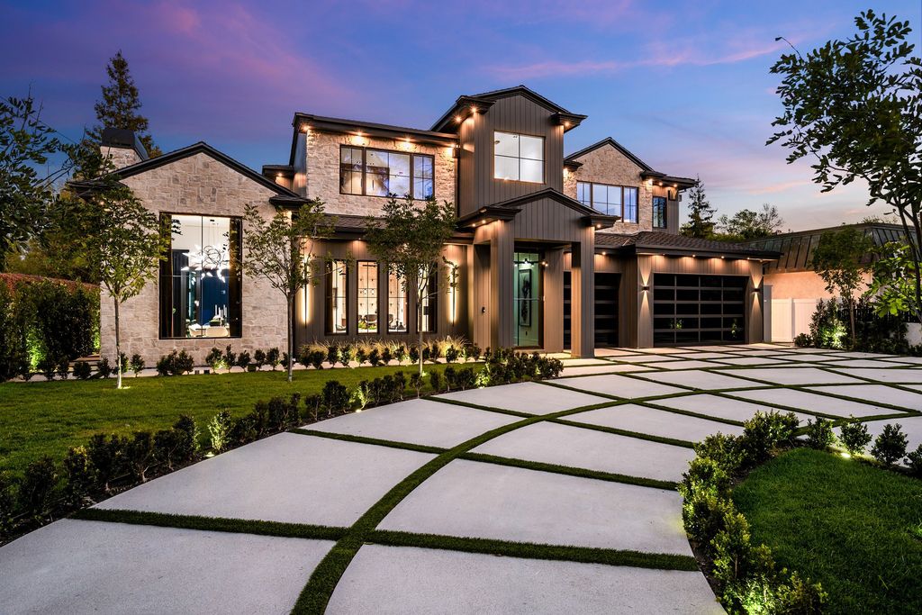 The recently built gated estate at 4508 Haskell Ave in Encino's prestigious Royal Oaks community is a true masterpiece of luxury and design. Upon entering the property, guests are welcomed by an impressive wide entry hallway with ultra-high ceilings and European oak floors. The hallway leads to the stunning living room with stone entertainment bars and a formal dining room with a fireplace and private patio.