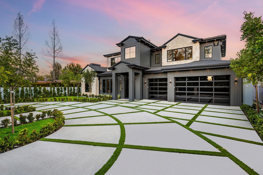 The recently built gated estate at 4508 Haskell Ave in Encino's prestigious Royal Oaks community is a true masterpiece of luxury and design. Upon entering the property, guests are welcomed by an impressive wide entry hallway with ultra-high ceilings and European oak floors. The hallway leads to the stunning living room with stone entertainment bars and a formal dining room with a fireplace and private patio.