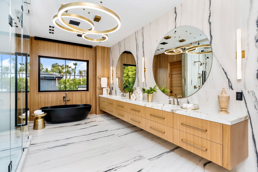 The recently built gated estate at 4508 Haskell Ave in Encino's prestigious Royal Oaks community is a true masterpiece of luxury and design. Upon entering the property, guests are welcomed by an impressive wide entry hallway with ultra-high ceilings and European oak floors. The hallway leads to the stunning living room with stone entertainment bars and a formal dining room with a fireplace and private patio.