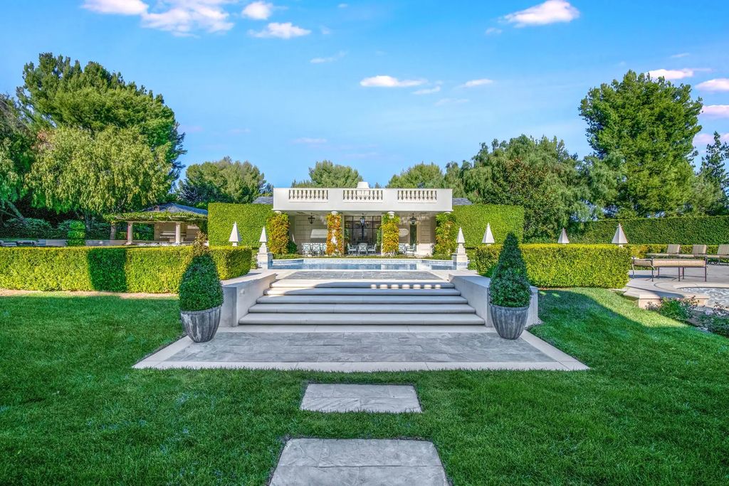 55 Beverly Park is a grand-scale residence located in the exclusive guard-gated enclave of Beverly Park. This luxurious estate, expertly designed by acclaimed architect Bob Ray Offenhauser, exudes an air of French Chateau meets Southern California living, and sits on 2.89 acres of romantic French-style garden landscaping.