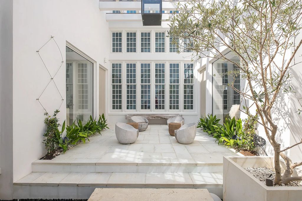 This stunning modernist retreat in the heart of Alys Beach, located at 116 S Charles Street, Inlet Beach, Florida, is a bespoke light-filled home with extraordinary architectural styling and sophisticated interior design.