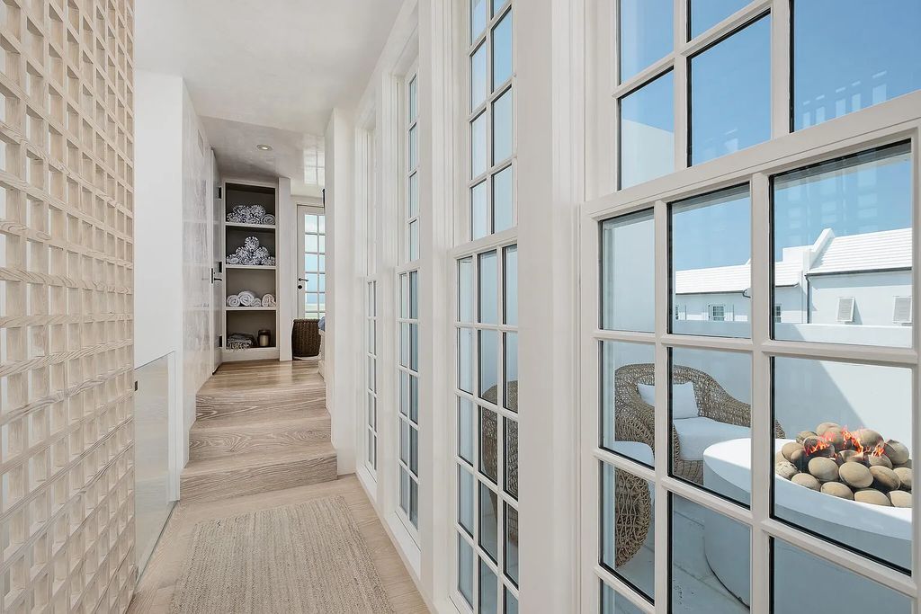 This stunning modernist retreat in the heart of Alys Beach, located at 116 S Charles Street, Inlet Beach, Florida, is a bespoke light-filled home with extraordinary architectural styling and sophisticated interior design.