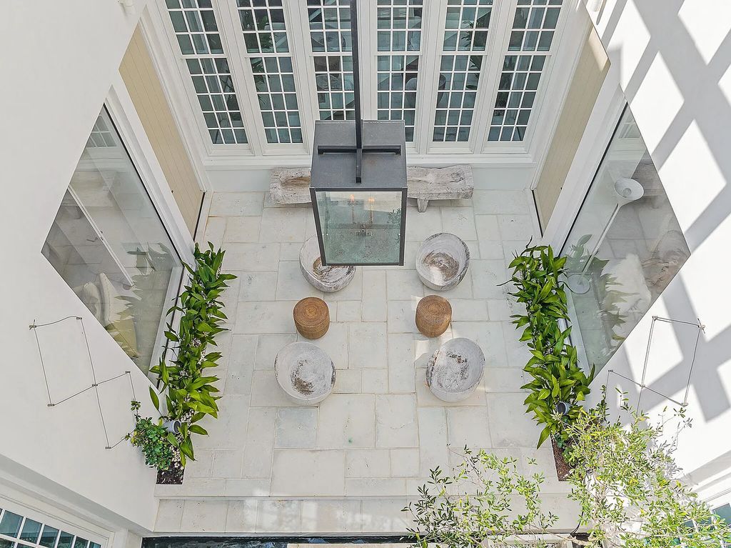 This stunning modernist retreat in the heart of Alys Beach, located at 116 S Charles Street, Inlet Beach, Florida, is a bespoke light-filled home with extraordinary architectural styling and sophisticated interior design.