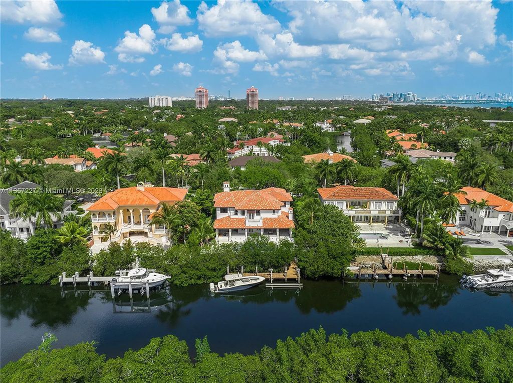 This stunning waterfront home is located at 152 Paloma Drive in the exclusive gated community of Islands of Cocoplum in Coral Gables, Florida. It features 6 bedrooms, 5.5 bathrooms, a brand new kitchen with top-of-the-line appliances, impact windows throughout, and a fabulous custom bar.