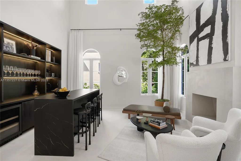This stunning waterfront home is located at 152 Paloma Drive in the exclusive gated community of Islands of Cocoplum in Coral Gables, Florida. It features 6 bedrooms, 5.5 bathrooms, a brand new kitchen with top-of-the-line appliances, impact windows throughout, and a fabulous custom bar.