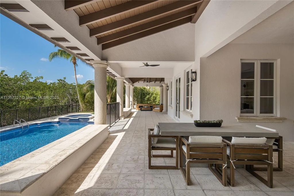 This stunning waterfront home is located at 152 Paloma Drive in the exclusive gated community of Islands of Cocoplum in Coral Gables, Florida. It features 6 bedrooms, 5.5 bathrooms, a brand new kitchen with top-of-the-line appliances, impact windows throughout, and a fabulous custom bar.