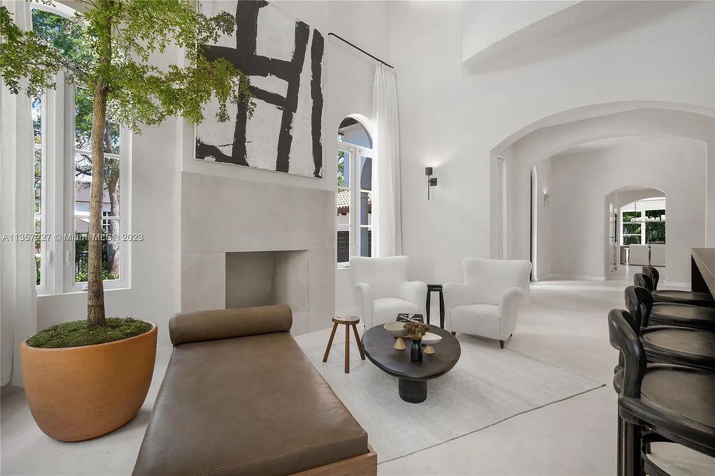 This stunning waterfront home is located at 152 Paloma Drive in the exclusive gated community of Islands of Cocoplum in Coral Gables, Florida. It features 6 bedrooms, 5.5 bathrooms, a brand new kitchen with top-of-the-line appliances, impact windows throughout, and a fabulous custom bar.