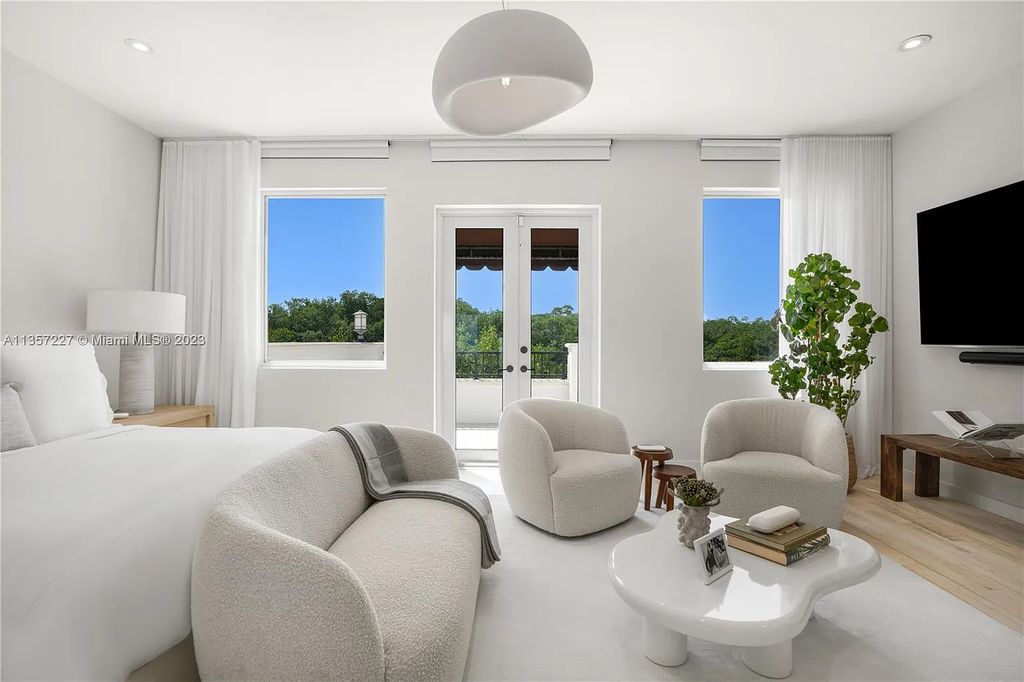 This stunning waterfront home is located at 152 Paloma Drive in the exclusive gated community of Islands of Cocoplum in Coral Gables, Florida. It features 6 bedrooms, 5.5 bathrooms, a brand new kitchen with top-of-the-line appliances, impact windows throughout, and a fabulous custom bar.