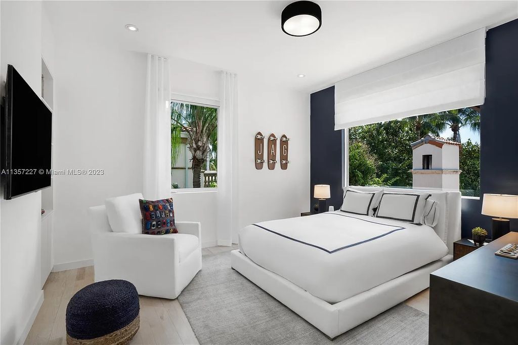 This stunning waterfront home is located at 152 Paloma Drive in the exclusive gated community of Islands of Cocoplum in Coral Gables, Florida. It features 6 bedrooms, 5.5 bathrooms, a brand new kitchen with top-of-the-line appliances, impact windows throughout, and a fabulous custom bar.