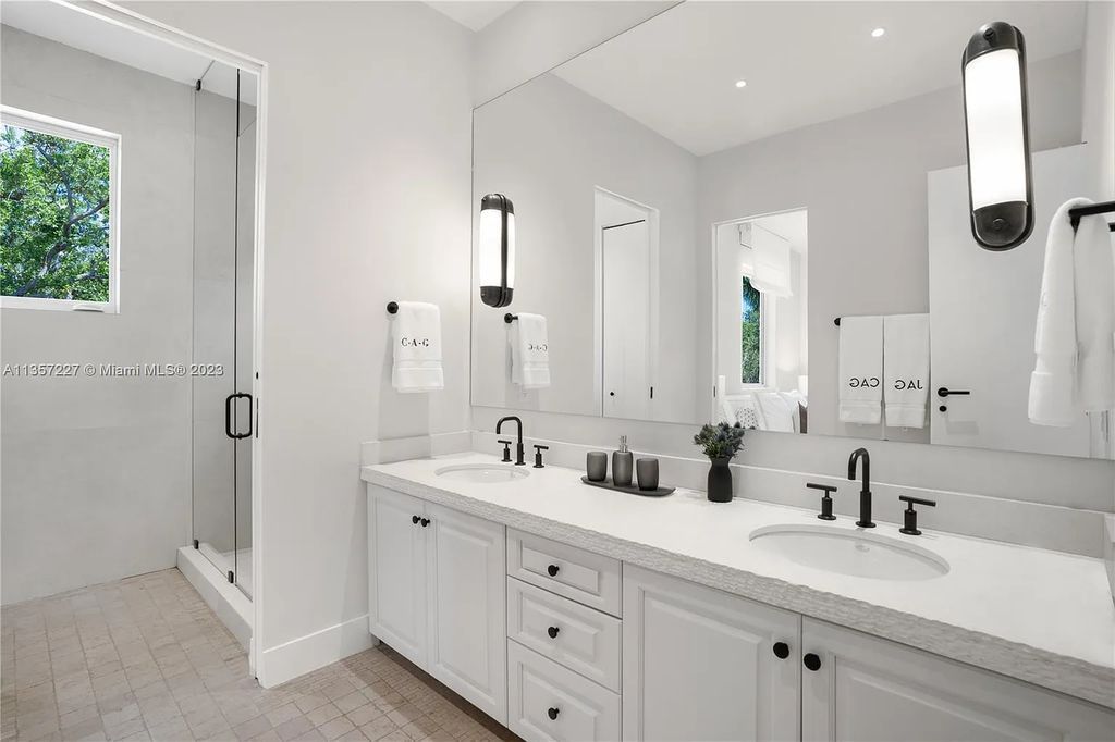 This stunning waterfront home is located at 152 Paloma Drive in the exclusive gated community of Islands of Cocoplum in Coral Gables, Florida. It features 6 bedrooms, 5.5 bathrooms, a brand new kitchen with top-of-the-line appliances, impact windows throughout, and a fabulous custom bar.