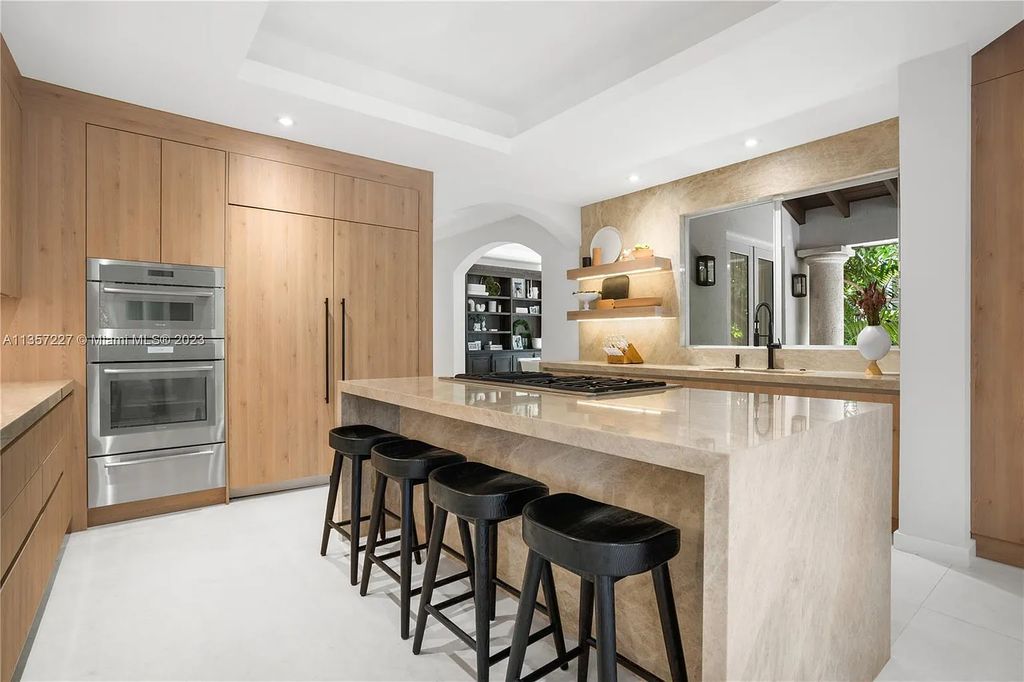 This stunning waterfront home is located at 152 Paloma Drive in the exclusive gated community of Islands of Cocoplum in Coral Gables, Florida. It features 6 bedrooms, 5.5 bathrooms, a brand new kitchen with top-of-the-line appliances, impact windows throughout, and a fabulous custom bar.