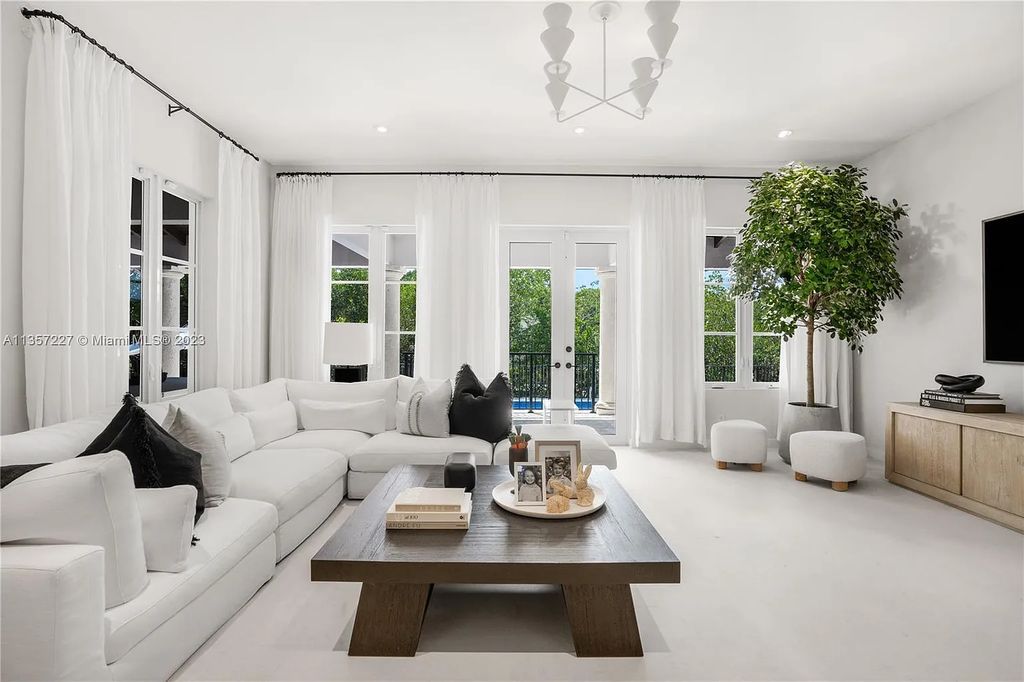 This stunning waterfront home is located at 152 Paloma Drive in the exclusive gated community of Islands of Cocoplum in Coral Gables, Florida. It features 6 bedrooms, 5.5 bathrooms, a brand new kitchen with top-of-the-line appliances, impact windows throughout, and a fabulous custom bar.