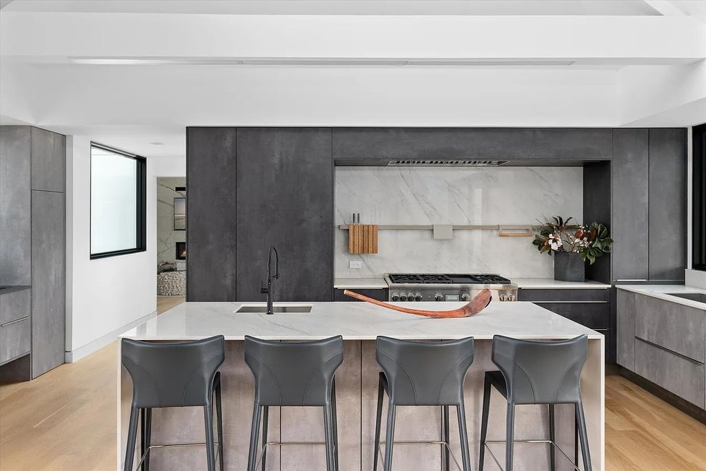 The House in Bridgehampton features an entertainer's floor plan that flows seamlessly into each room with an abundance of natural light, now available for sale. This home located at 1076 Ocean Rd, Bridgehampton, New York