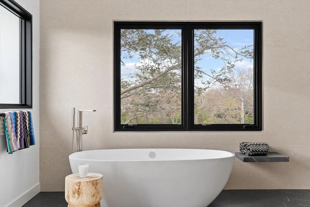 The House in Bridgehampton features an entertainer's floor plan that flows seamlessly into each room with an abundance of natural light, now available for sale. This home located at 1076 Ocean Rd, Bridgehampton, New York