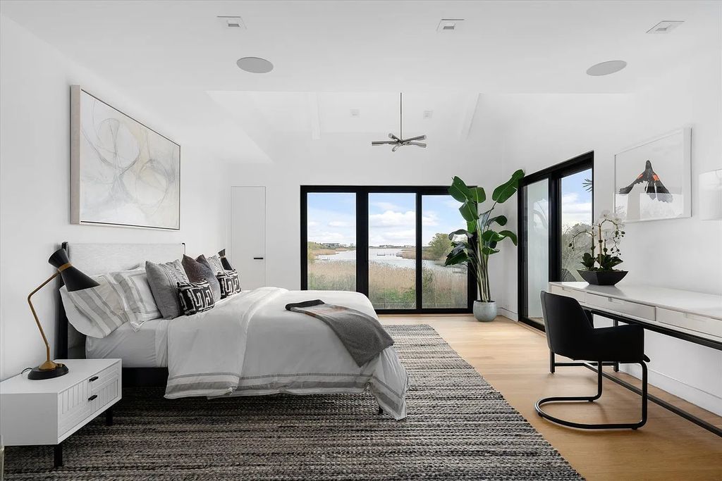 The House in Bridgehampton features an entertainer's floor plan that flows seamlessly into each room with an abundance of natural light, now available for sale. This home located at 1076 Ocean Rd, Bridgehampton, New York