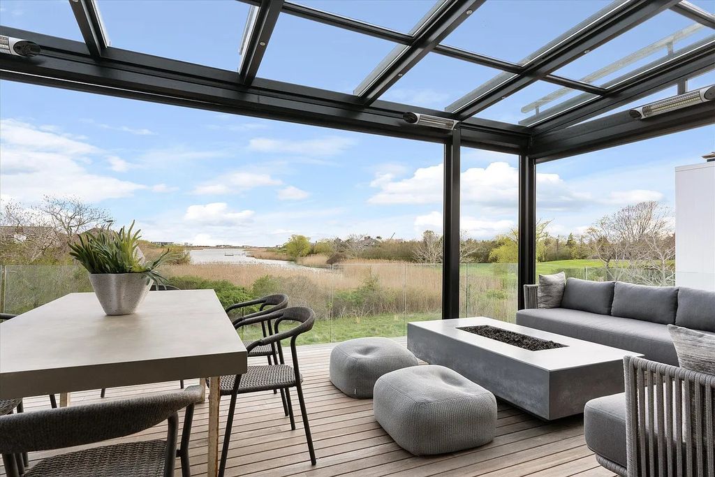 The House in Bridgehampton features an entertainer's floor plan that flows seamlessly into each room with an abundance of natural light, now available for sale. This home located at 1076 Ocean Rd, Bridgehampton, New York