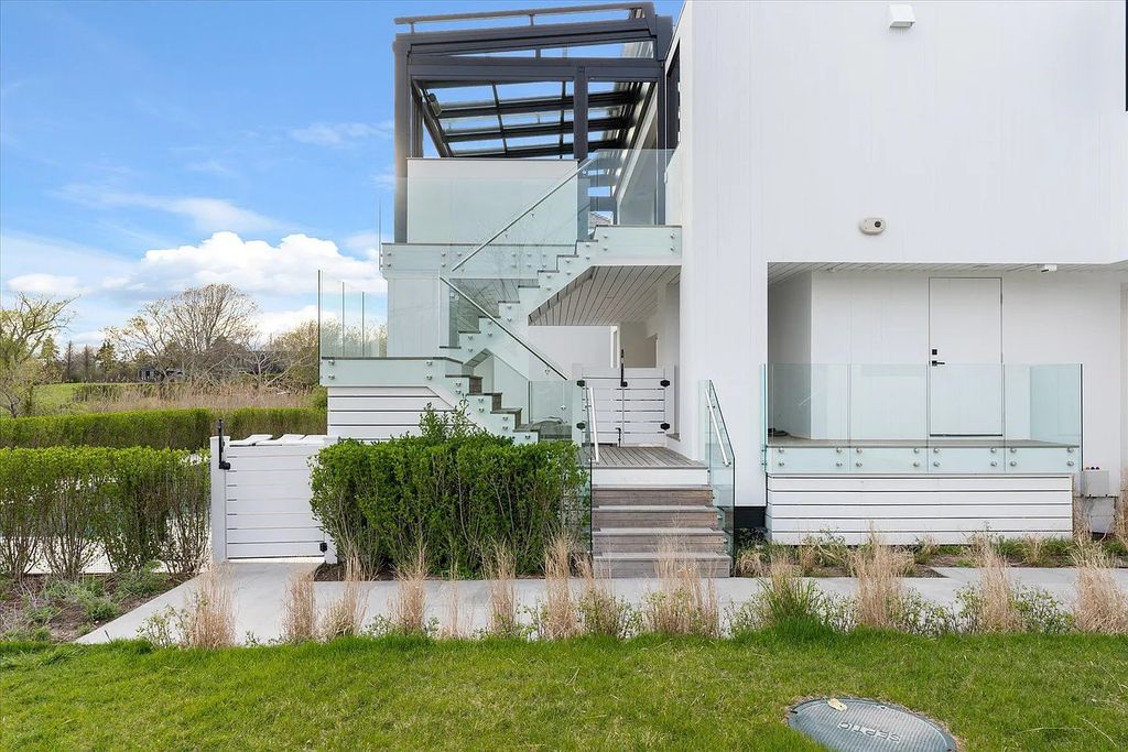 The House in Bridgehampton features an entertainer's floor plan that flows seamlessly into each room with an abundance of natural light, now available for sale. This home located at 1076 Ocean Rd, Bridgehampton, New York