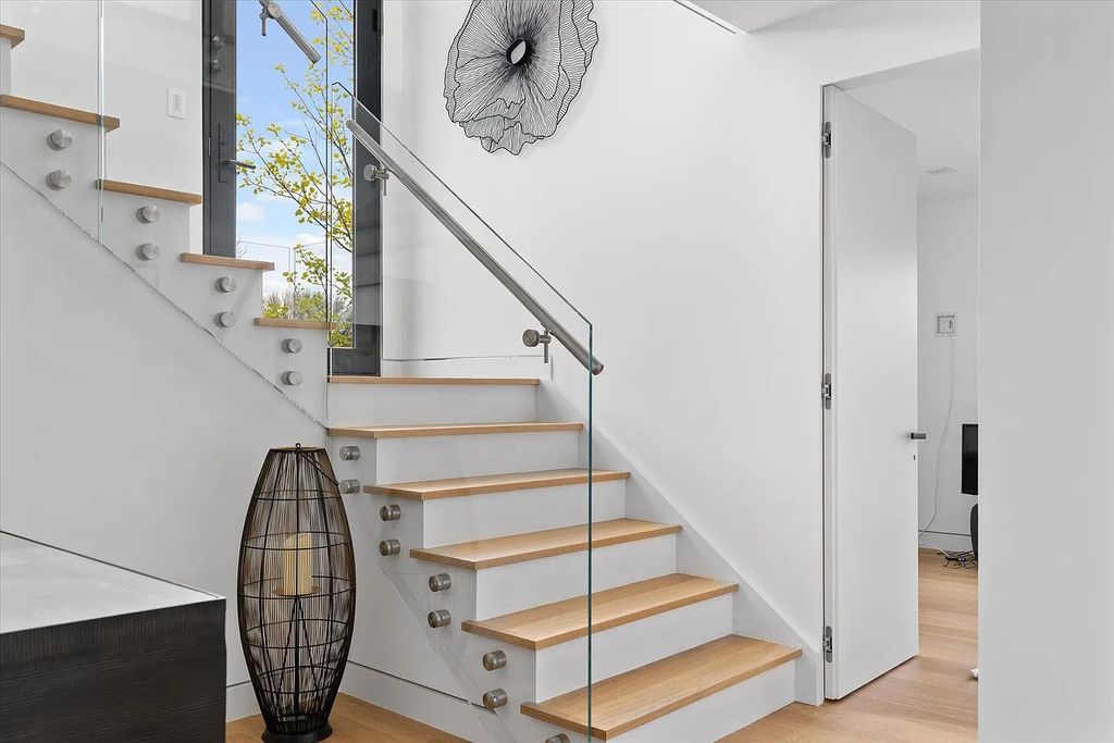 The House in Bridgehampton features an entertainer's floor plan that flows seamlessly into each room with an abundance of natural light, now available for sale. This home located at 1076 Ocean Rd, Bridgehampton, New York