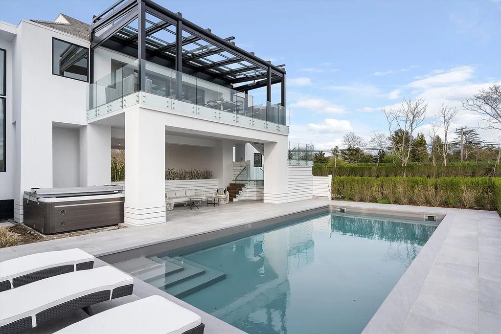 The House in Bridgehampton features an entertainer's floor plan that flows seamlessly into each room with an abundance of natural light, now available for sale. This home located at 1076 Ocean Rd, Bridgehampton, New York