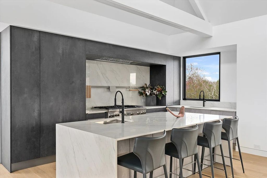 The House in Bridgehampton features an entertainer's floor plan that flows seamlessly into each room with an abundance of natural light, now available for sale. This home located at 1076 Ocean Rd, Bridgehampton, New York