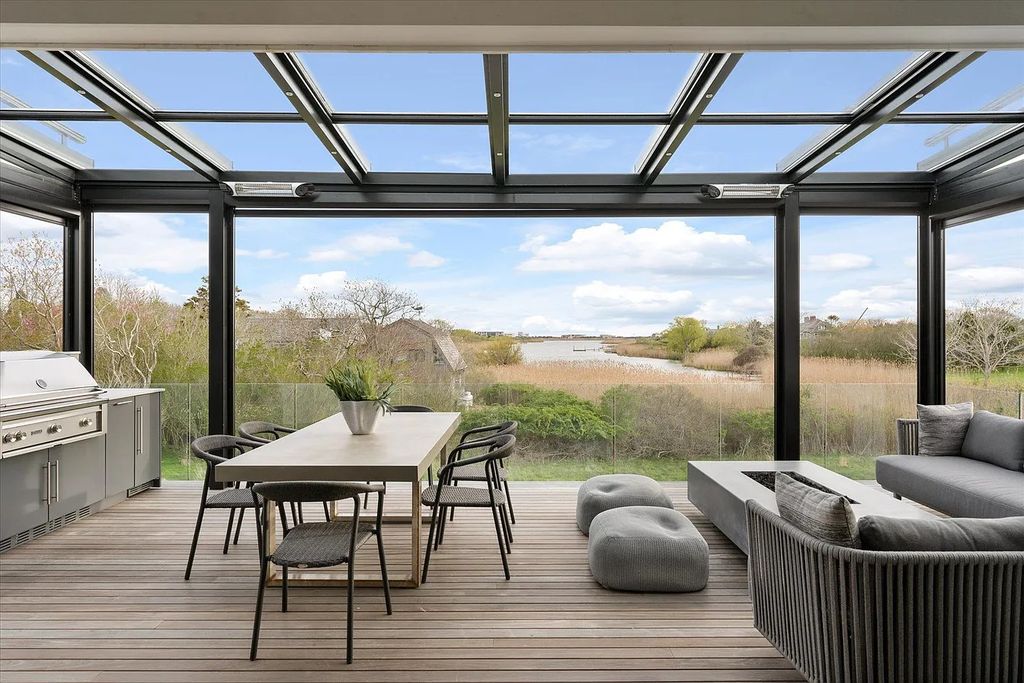 The House in Bridgehampton features an entertainer's floor plan that flows seamlessly into each room with an abundance of natural light, now available for sale. This home located at 1076 Ocean Rd, Bridgehampton, New York