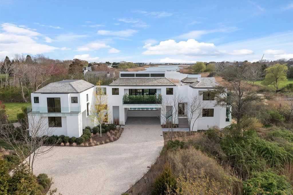The House in Bridgehampton features an entertainer's floor plan that flows seamlessly into each room with an abundance of natural light, now available for sale. This home located at 1076 Ocean Rd, Bridgehampton, New York