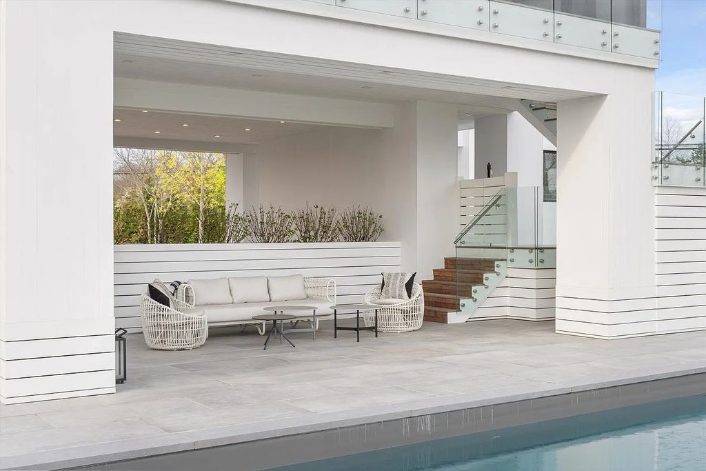 The House in Bridgehampton features an entertainer's floor plan that flows seamlessly into each room with an abundance of natural light, now available for sale. This home located at 1076 Ocean Rd, Bridgehampton, New York