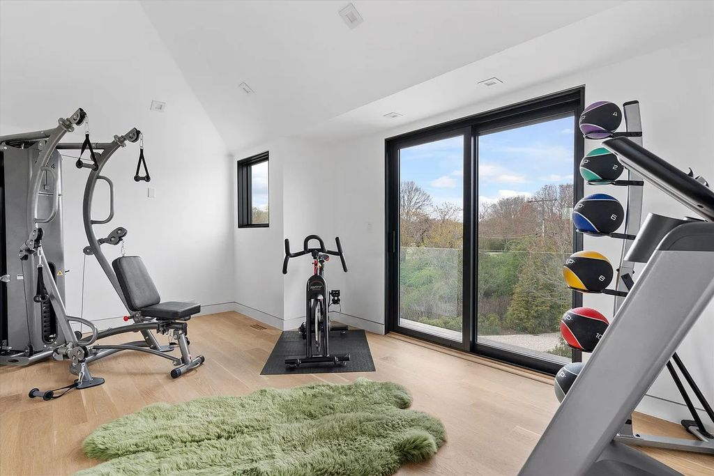 The House in Bridgehampton features an entertainer's floor plan that flows seamlessly into each room with an abundance of natural light, now available for sale. This home located at 1076 Ocean Rd, Bridgehampton, New York