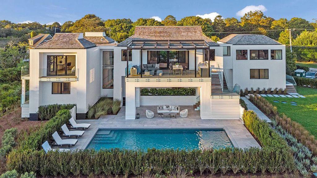 The House in Bridgehampton features an entertainer's floor plan that flows seamlessly into each room with an abundance of natural light, now available for sale. This home located at 1076 Ocean Rd, Bridgehampton, New York