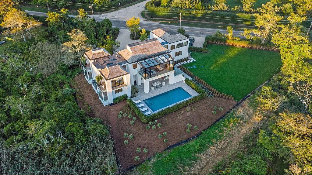 The House in Bridgehampton features an entertainer's floor plan that flows seamlessly into each room with an abundance of natural light, now available for sale. This home located at 1076 Ocean Rd, Bridgehampton, New York