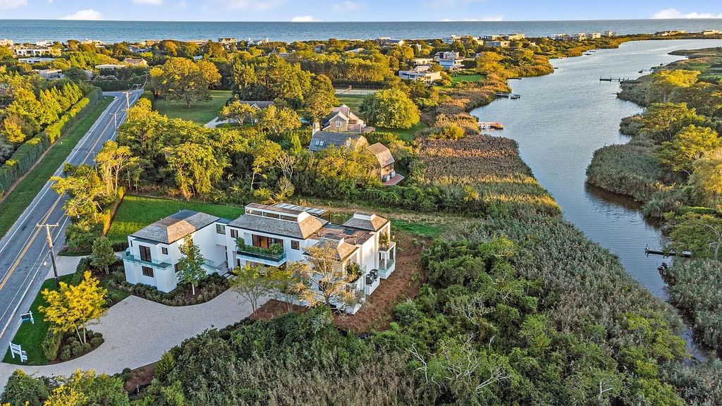The House in Bridgehampton features an entertainer's floor plan that flows seamlessly into each room with an abundance of natural light, now available for sale. This home located at 1076 Ocean Rd, Bridgehampton, New York