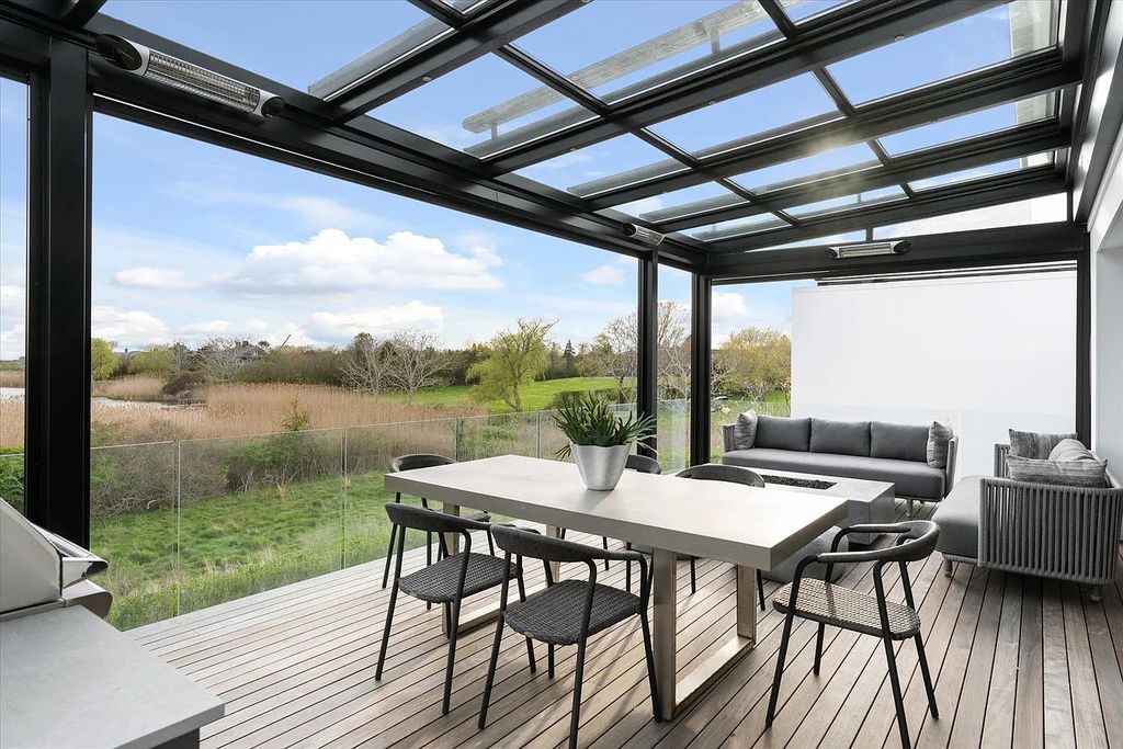 The House in Bridgehampton features an entertainer's floor plan that flows seamlessly into each room with an abundance of natural light, now available for sale. This home located at 1076 Ocean Rd, Bridgehampton, New York