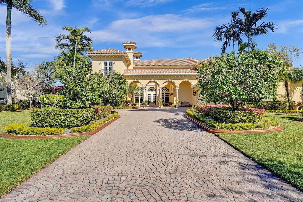 3308 Islewood Avenue, Weston, Florida is located in the prestigious gated community of Windmill Reserve, and it offers luxurious living on a grand scale. Situated on a premium lake lot with a lushly landscaped yard, this home in Weston features a gas-heated pool/spa, covered summer kitchen, Chicago brick patio, and roll-down shades, making it perfect for entertaining guests or enjoying time with family.