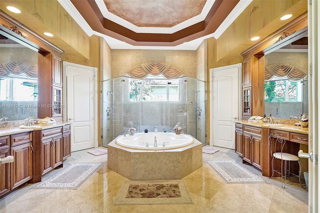 3308 Islewood Avenue, Weston, Florida is located in the prestigious gated community of Windmill Reserve, and it offers luxurious living on a grand scale. Situated on a premium lake lot with a lushly landscaped yard, this home in Weston features a gas-heated pool/spa, covered summer kitchen, Chicago brick patio, and roll-down shades, making it perfect for entertaining guests or enjoying time with family.