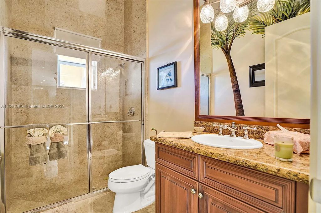 3308 Islewood Avenue, Weston, Florida is located in the prestigious gated community of Windmill Reserve, and it offers luxurious living on a grand scale. Situated on a premium lake lot with a lushly landscaped yard, this home in Weston features a gas-heated pool/spa, covered summer kitchen, Chicago brick patio, and roll-down shades, making it perfect for entertaining guests or enjoying time with family.