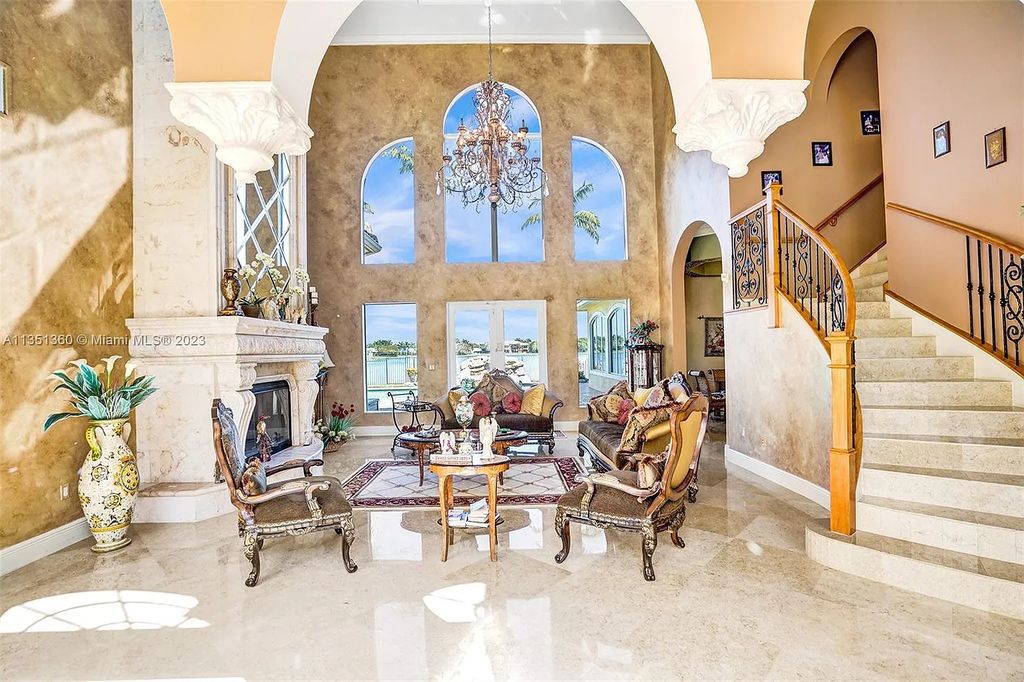 3308 Islewood Avenue, Weston, Florida is located in the prestigious gated community of Windmill Reserve, and it offers luxurious living on a grand scale. Situated on a premium lake lot with a lushly landscaped yard, this home in Weston features a gas-heated pool/spa, covered summer kitchen, Chicago brick patio, and roll-down shades, making it perfect for entertaining guests or enjoying time with family.