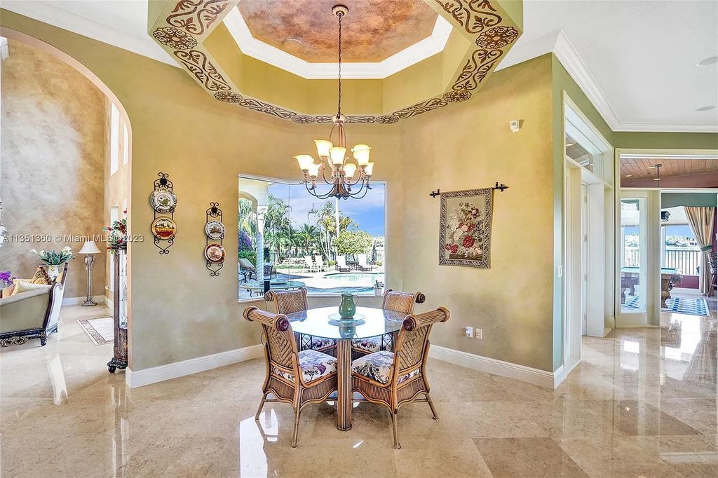 3308 Islewood Avenue, Weston, Florida is located in the prestigious gated community of Windmill Reserve, and it offers luxurious living on a grand scale. Situated on a premium lake lot with a lushly landscaped yard, this home in Weston features a gas-heated pool/spa, covered summer kitchen, Chicago brick patio, and roll-down shades, making it perfect for entertaining guests or enjoying time with family.