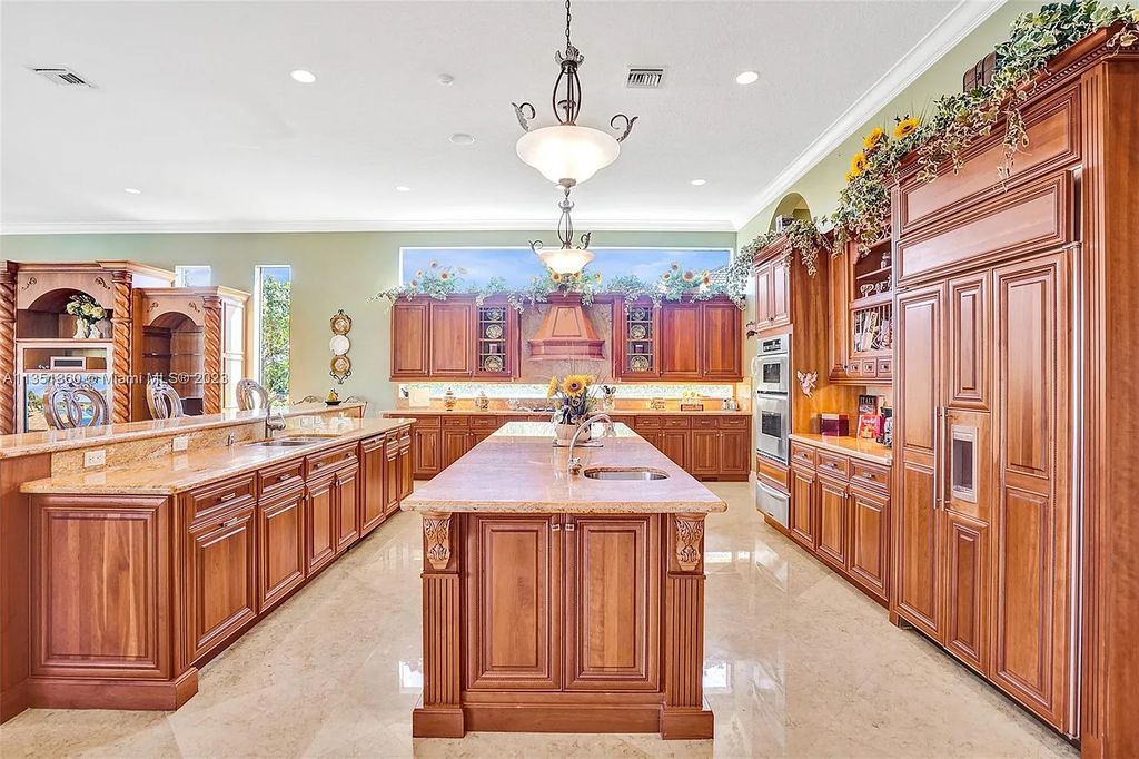 3308 Islewood Avenue, Weston, Florida is located in the prestigious gated community of Windmill Reserve, and it offers luxurious living on a grand scale. Situated on a premium lake lot with a lushly landscaped yard, this home in Weston features a gas-heated pool/spa, covered summer kitchen, Chicago brick patio, and roll-down shades, making it perfect for entertaining guests or enjoying time with family.