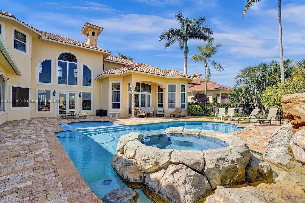 3308 Islewood Avenue, Weston, Florida is located in the prestigious gated community of Windmill Reserve, and it offers luxurious living on a grand scale. Situated on a premium lake lot with a lushly landscaped yard, this home in Weston features a gas-heated pool/spa, covered summer kitchen, Chicago brick patio, and roll-down shades, making it perfect for entertaining guests or enjoying time with family.