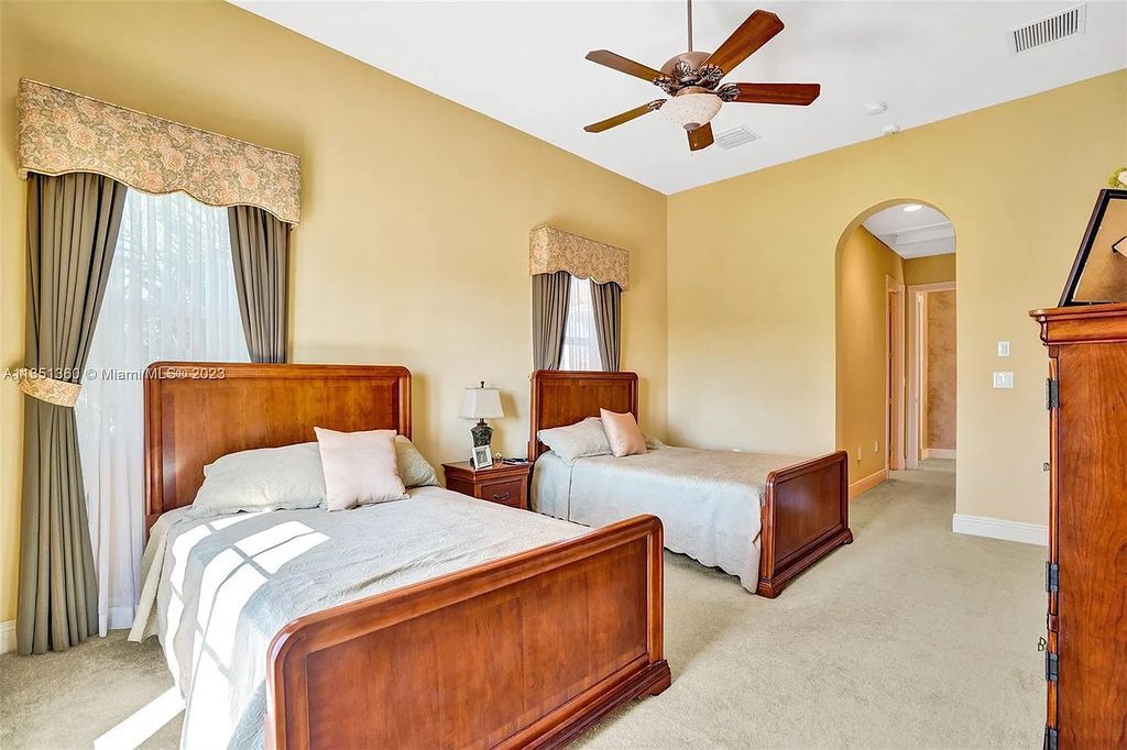 3308 Islewood Avenue, Weston, Florida is located in the prestigious gated community of Windmill Reserve, and it offers luxurious living on a grand scale. Situated on a premium lake lot with a lushly landscaped yard, this home in Weston features a gas-heated pool/spa, covered summer kitchen, Chicago brick patio, and roll-down shades, making it perfect for entertaining guests or enjoying time with family.