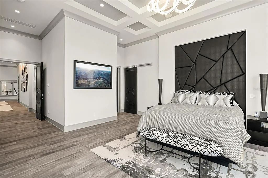 This luxurious lakefront mansion at 9306 Blanche Cove Drive in Windermere, Florida, is a custom-crafted masterpiece built for the ultimate sports enthusiast. The 5-bedroom, 8-bath home spans 14,856 square feet and includes a 6,060 square foot air-conditioned full-sized basketball court, a theater, an exercise room with sauna, and a two-story master closet.