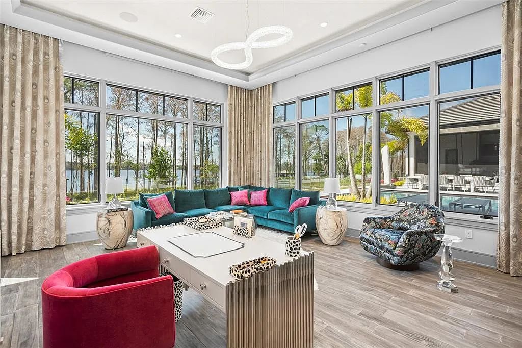 This luxurious lakefront mansion at 9306 Blanche Cove Drive in Windermere, Florida, is a custom-crafted masterpiece built for the ultimate sports enthusiast. The 5-bedroom, 8-bath home spans 14,856 square feet and includes a 6,060 square foot air-conditioned full-sized basketball court, a theater, an exercise room with sauna, and a two-story master closet.