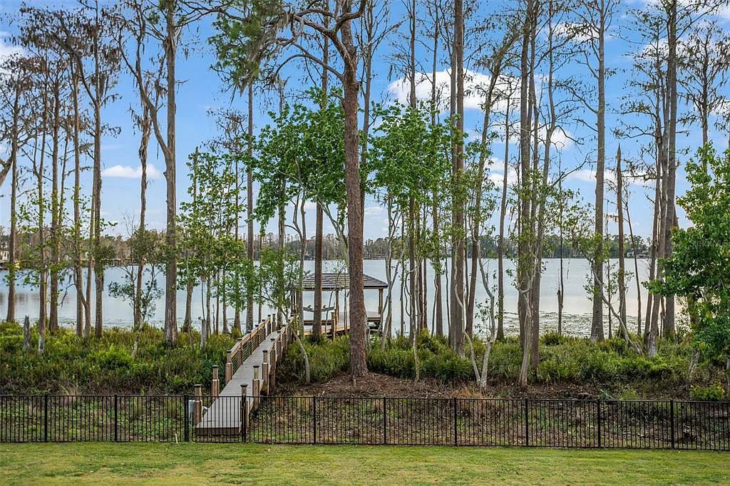 This luxurious lakefront mansion at 9306 Blanche Cove Drive in Windermere, Florida, is a custom-crafted masterpiece built for the ultimate sports enthusiast. The 5-bedroom, 8-bath home spans 14,856 square feet and includes a 6,060 square foot air-conditioned full-sized basketball court, a theater, an exercise room with sauna, and a two-story master closet.