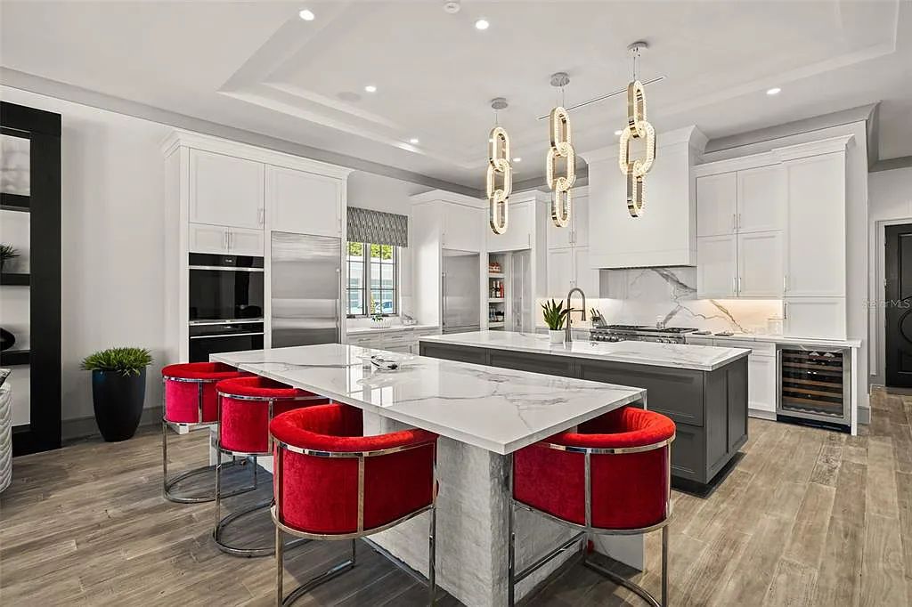 This luxurious lakefront mansion at 9306 Blanche Cove Drive in Windermere, Florida, is a custom-crafted masterpiece built for the ultimate sports enthusiast. The 5-bedroom, 8-bath home spans 14,856 square feet and includes a 6,060 square foot air-conditioned full-sized basketball court, a theater, an exercise room with sauna, and a two-story master closet.